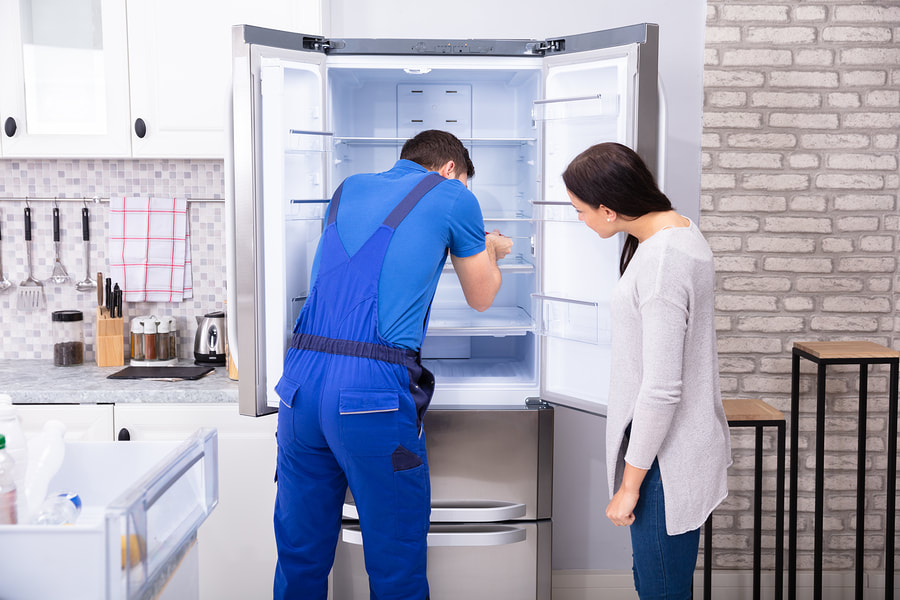 appliance expert doing fridge repair 