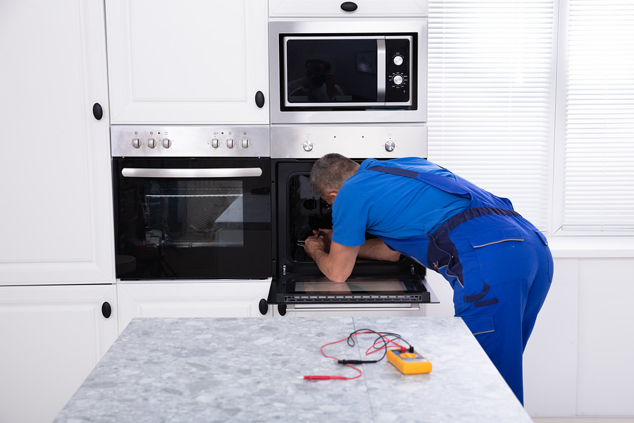 appliance expert doing oven repair 